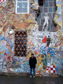 Jay in front of a mosaic at Metelkova Menza