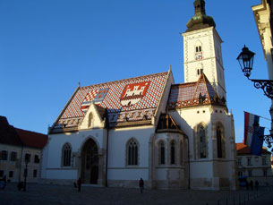Zagreb's St. Marks Church with a tiled roof bearing coats of arms for Zagreb and the Triune Kingdom of Croatia, Slavonia and Dalmatia